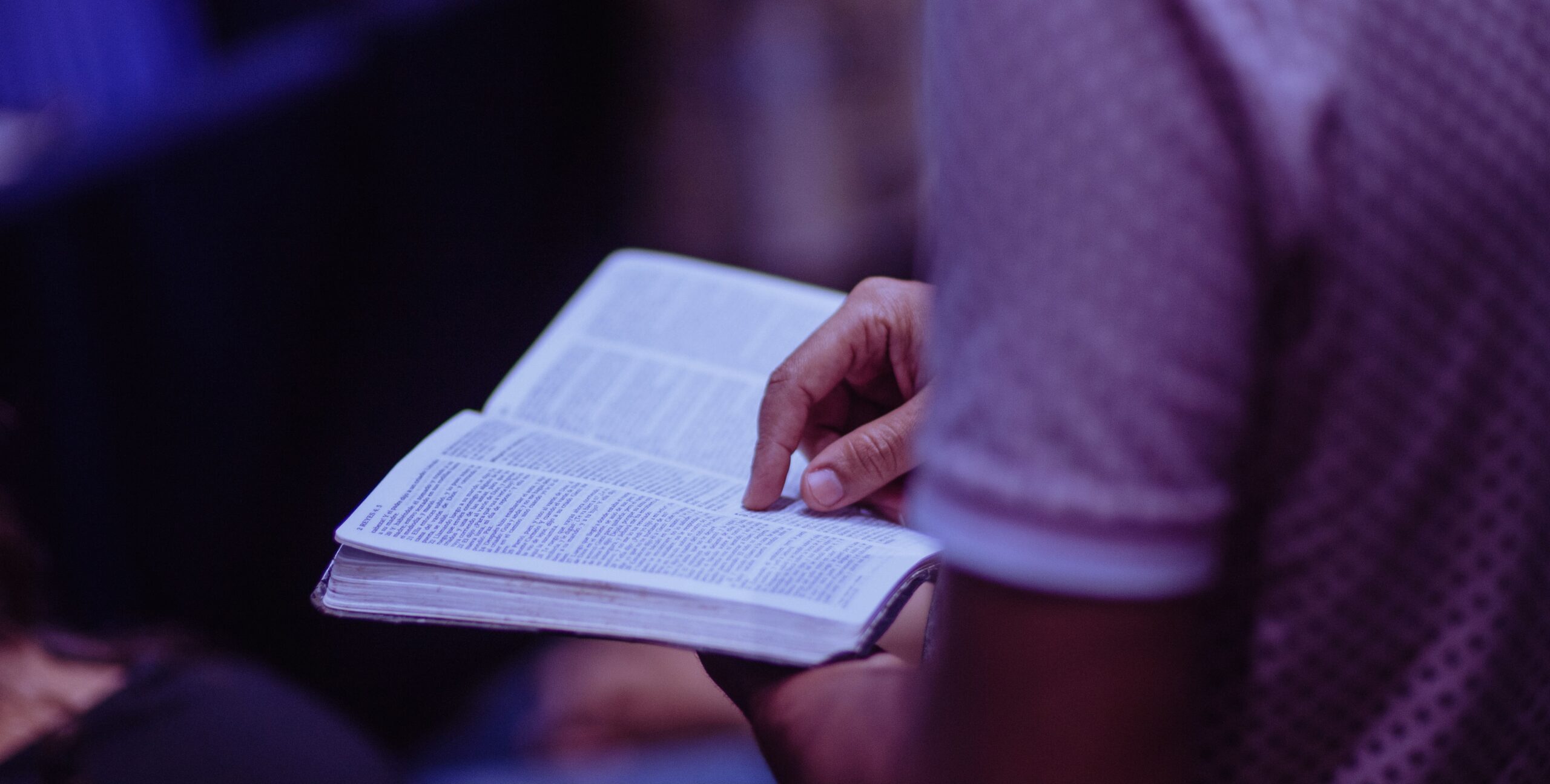 man with Bible open in church