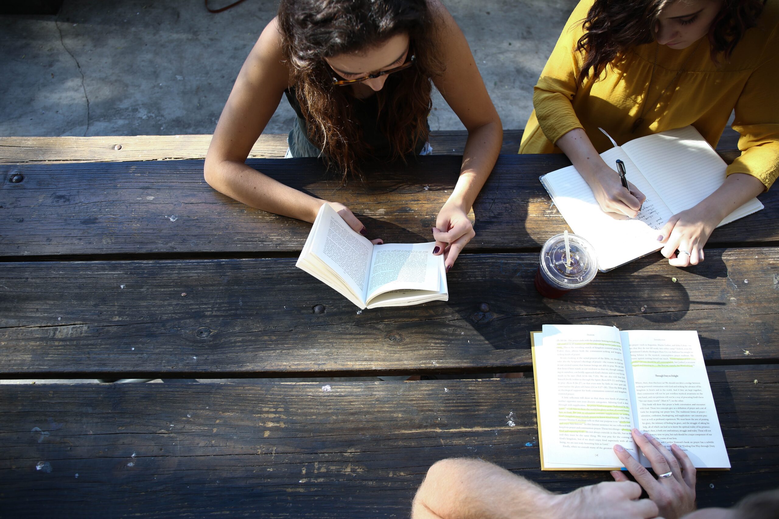 group sitting outdoors writing and being social