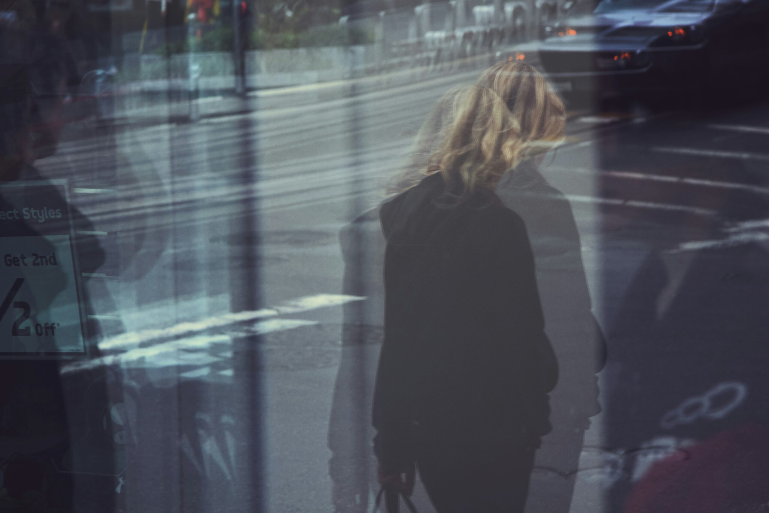 Blurred, distorted photo of someone from behind with long hair.